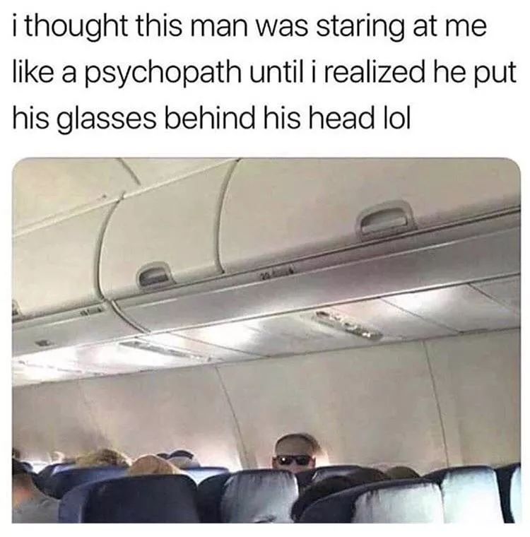 Guy wearing sunglasses backwards on plane