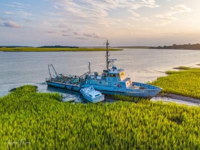 Navy vessel and small boat in Bohicket Creek